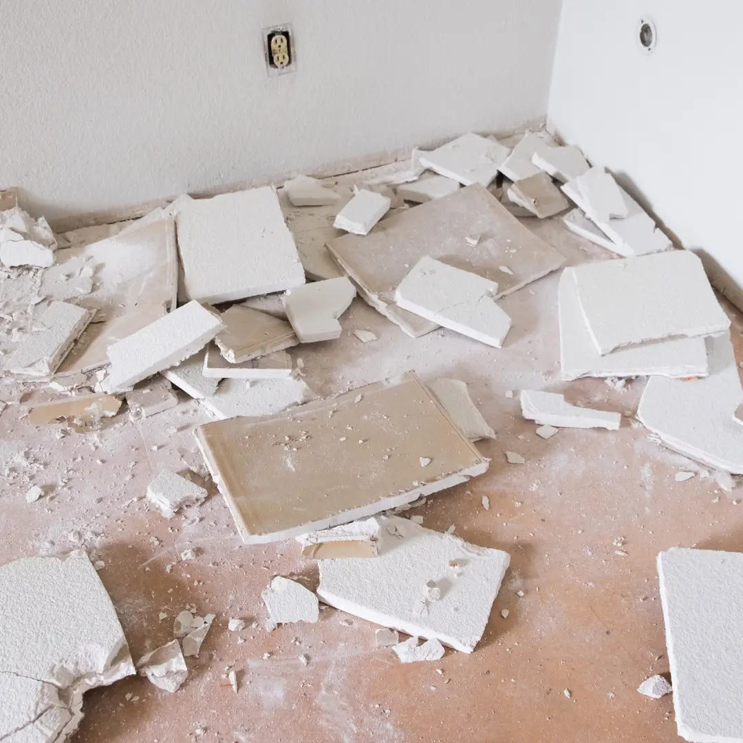 House renovation and major remodel with drywall making a huge mess as a wall is torn down at a construction site.<br />